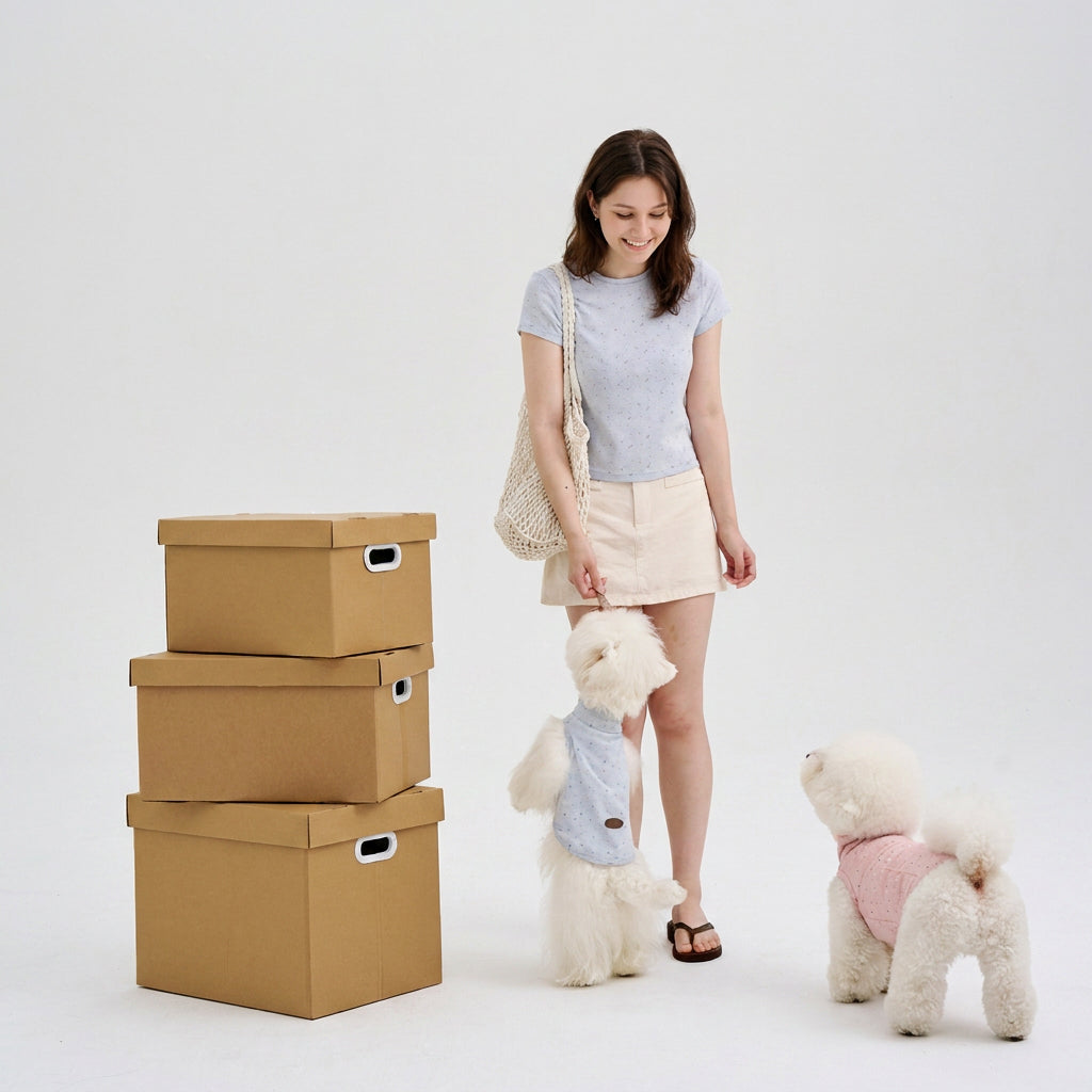 Pet parent wearing a light blue shirt with two small dogs in coordinated dog shirts, featuring casual dog apparel and cute small dog clothes for everyday matching style.