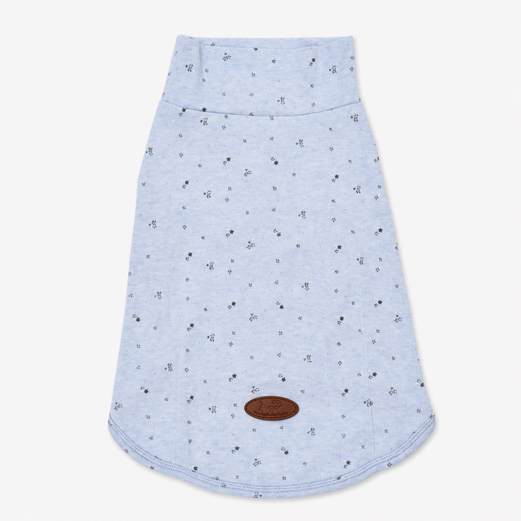 Flat lay of a light blue speckled dog tee with a curved hem and leather logo patch, featuring soft dog apparel and comfortable small dog clothes for everyday pet clothing.