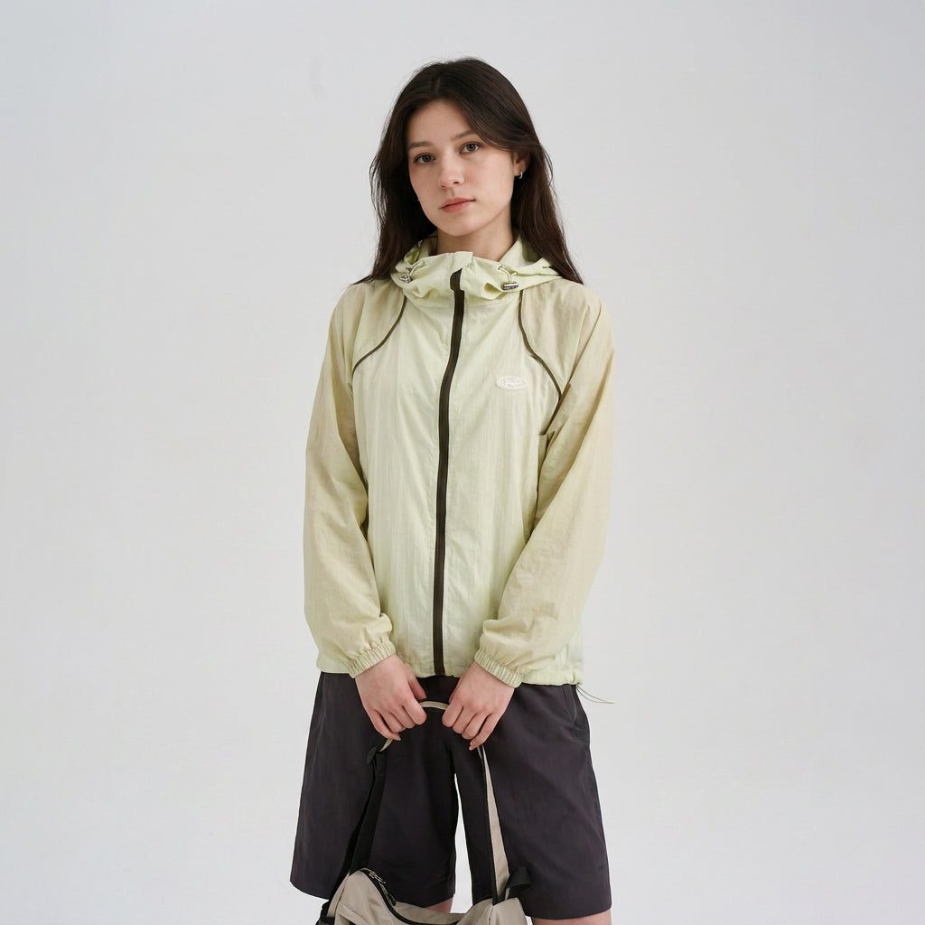 Pet parent wearing a pale green sun protection jacket, featuring lightweight owner outerwear designed to coordinate with dog sun jackets in matching pet parent outfits.
