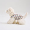 White small dog wearing a striped dog shirt with a casual sleeveless fit, featuring lightweight pet apparel for comfortable everyday dog clothes.